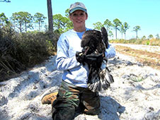 Becky Bolt, a wildlife ecologist with InoMedic Health Applications, Inc., holds one of the eaglets rescued on March 26. Photo credit: InoMedic Health Applications/Russ Lowers